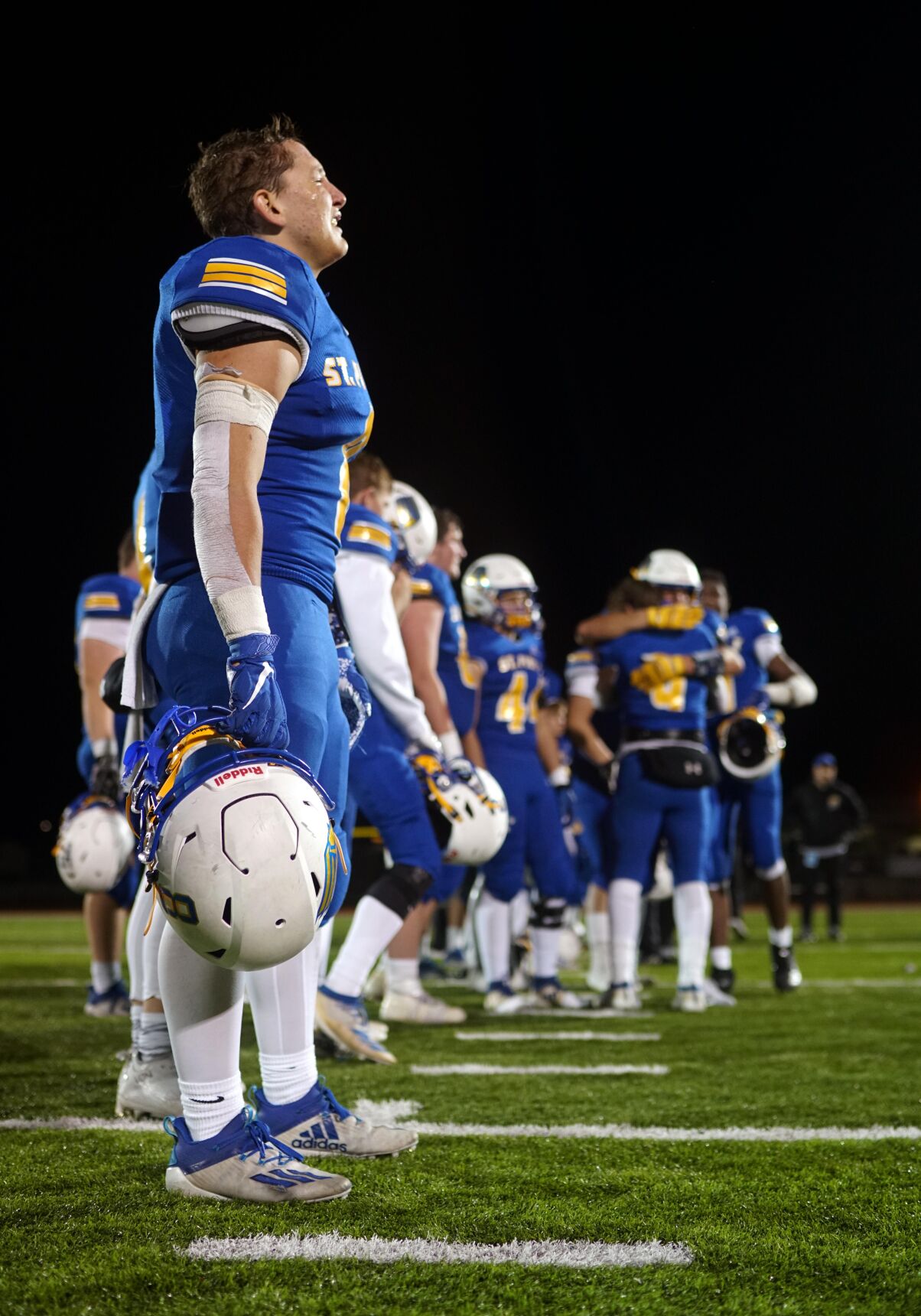 St. Pius X High School junior wide receiver John Caime cries